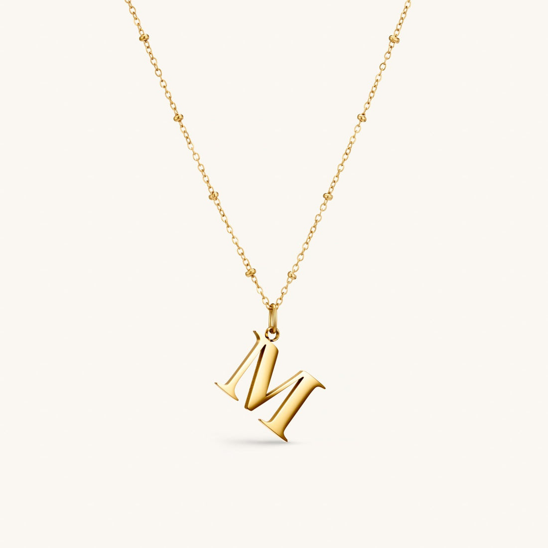 M Initial Necklace In Gold
