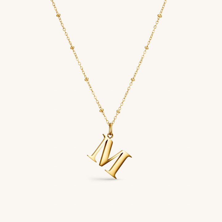 M Initial Necklace In Gold
